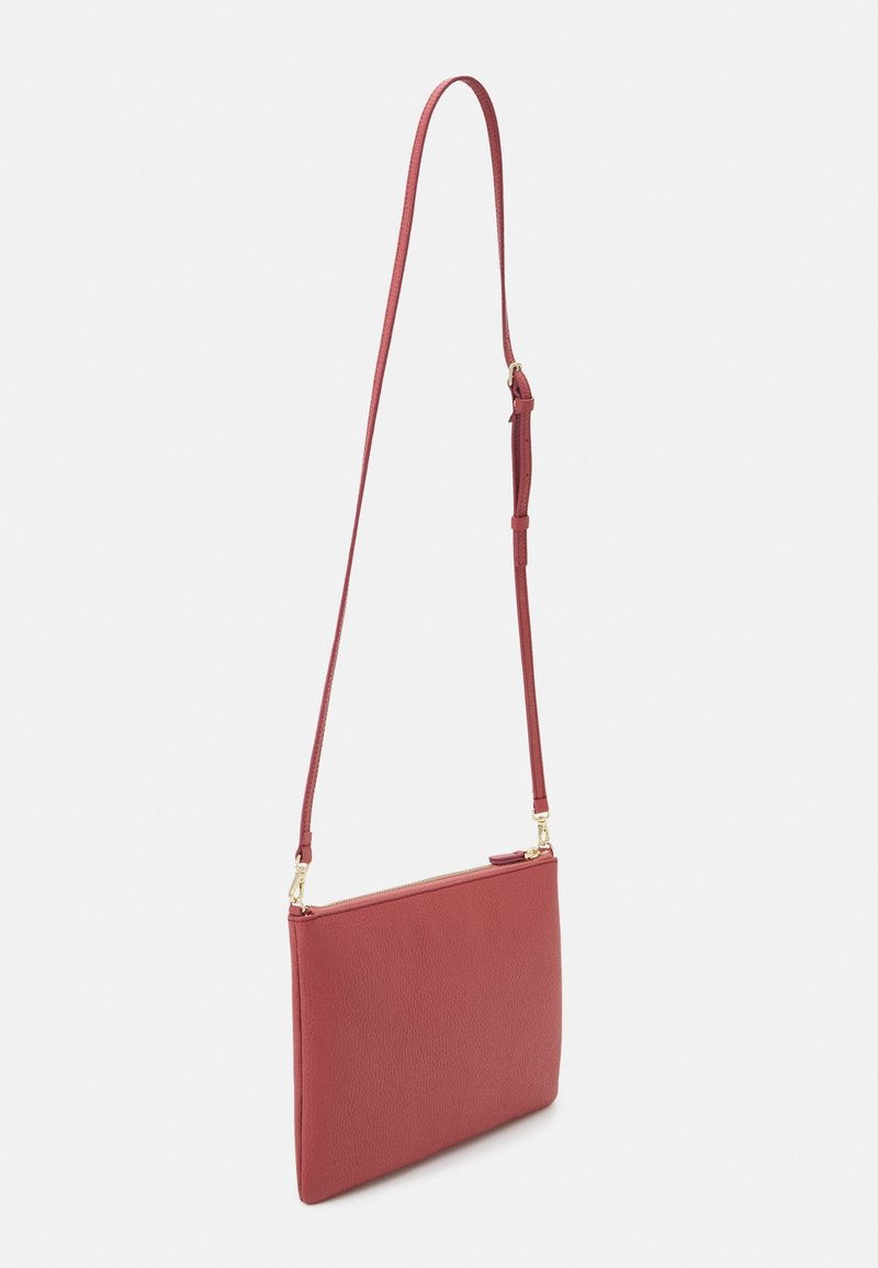 Red leather crossbody bag with a smooth texture, flat rectangular shape, adjustable strap, and a gold-toned zipper detail on top.