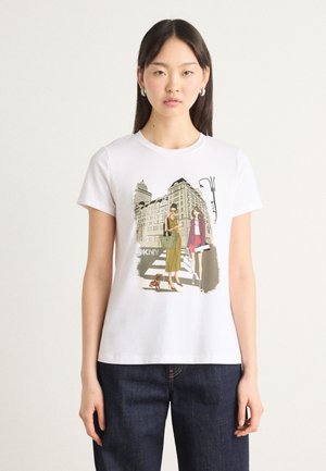 White cotton t-shirt featuring a colorful graphic of two women with a cityscape background. Short sleeves and crew neck design.
