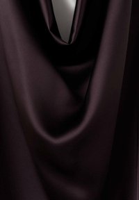 Dark purple satin fabric with a smooth, glossy texture, featuring soft draping and gentle folds that enhance its fluid appearance.