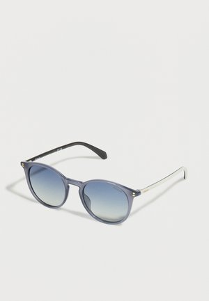 Blue gradient round sunglasses with black and white temples, Polaroid branding on lens and temple, resting on a white surface.