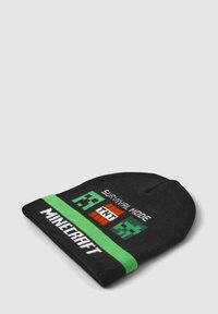 Czarny beanie z zieloną opaską. Zawiera napis "SURVIVAL MODE" oraz grafiki z gry Minecraft w białym i odcieniach zieleni. Materiał jest miękki i dziany.
