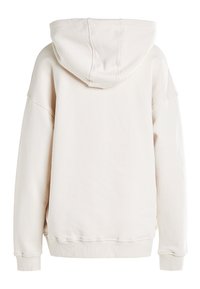 Felpa oversize beige chiaro con maniche lunghe, polsini e orlo a costine, e un grande cappuccio, vista da dietro su uno sfondo bianco.