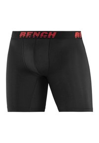 Black boxer shorts with a fitted design, elastic red waistband featuring the word "BENCH" in bold lettering. Smooth texture and no patterns.