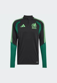 Fekete hosszú ujjú sportfelső zöld részletekkel. Negyedcipzáros nyakkal, mintás ujjakkal és egy Mexikó címerrel a mellkasán.