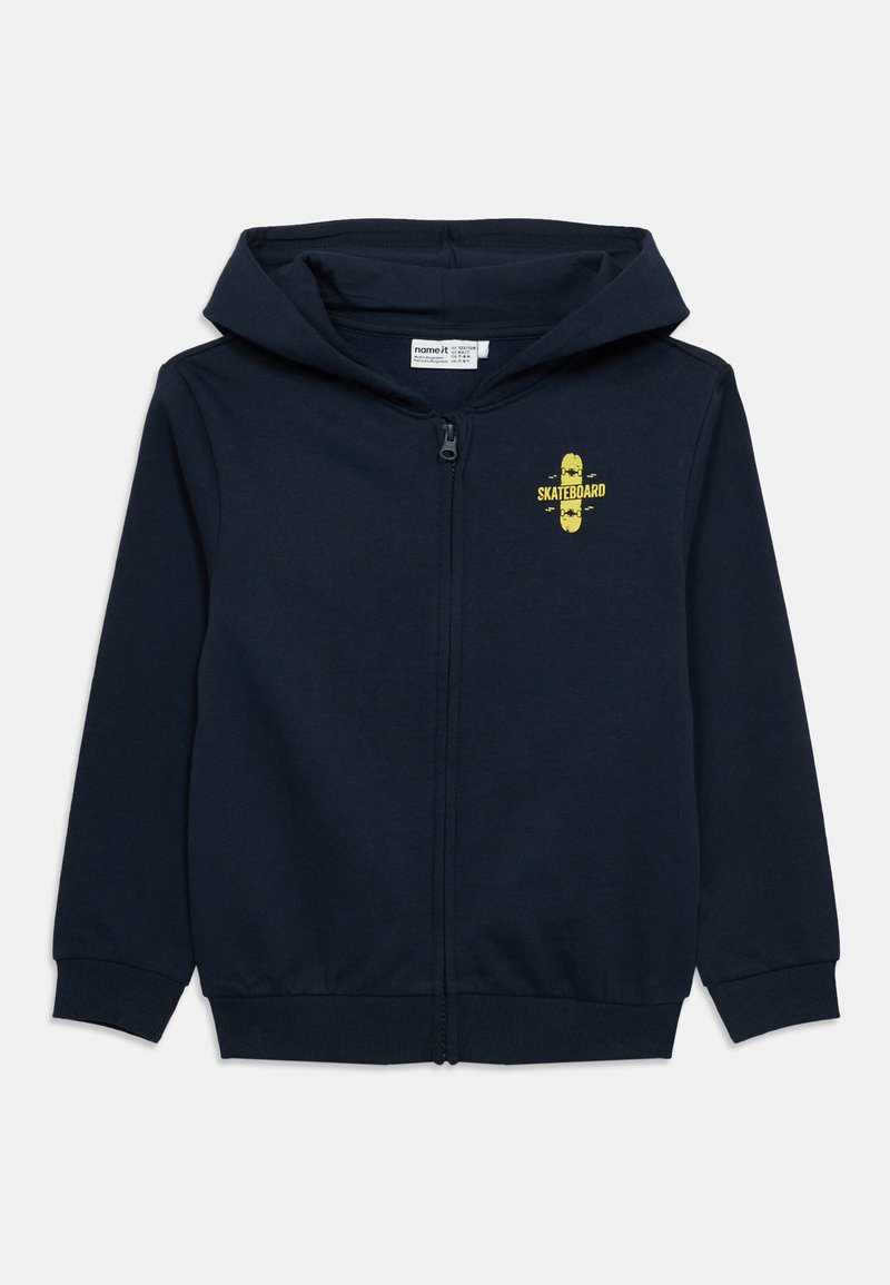 Námornícka tmavomodrá mikina na zips z bavlny, na hrudi so žltou grafikou skateboardu. Obsahuje klokanie vrecko a rebrované manžety.