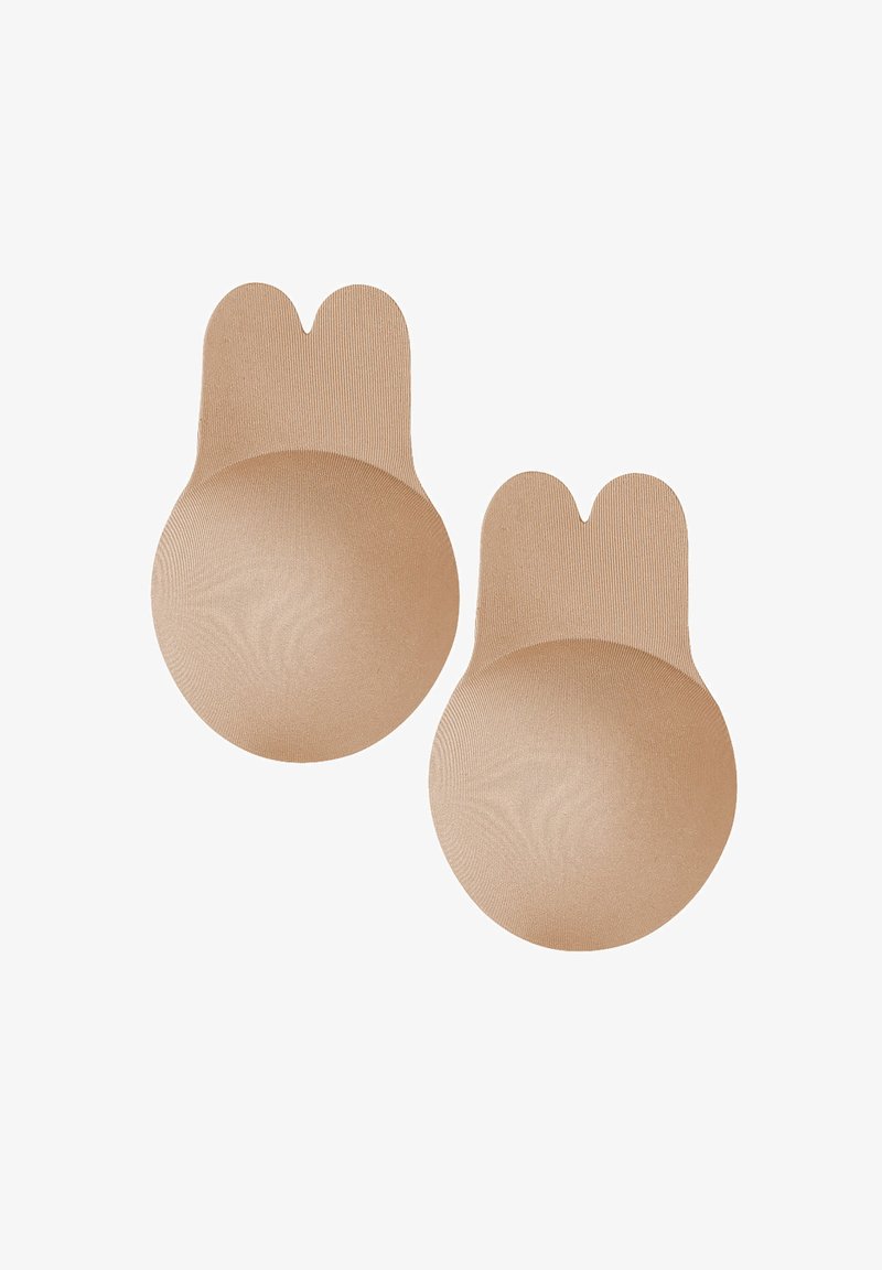 Paar beige Silikon-Brustwarzenabdeckungen mit doppelseitigem Zuglasche zur einfachen Entfernung, für diskrete Nutzung unter der Kleidung entworfen.