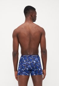Blue patterned boxer shorts with a navy elastic waistband featuring white text. The material appears soft with a fitted design.