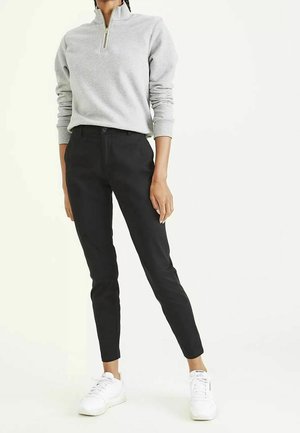 Gray zip-up sweatshirt with ribbed cuffs, paired with black fitted pants and white sneakers. Simple design and smooth textures.