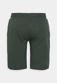Gröna shorts i bomullsblandning med mjuk textur, elastisk midja och en enda bakficka. Designen har en enkel, ren form.
