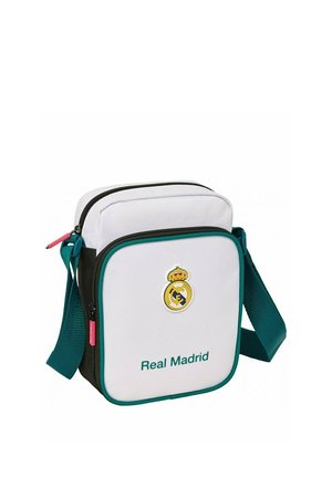 Mała biała i czarna torebka na ramię z turkusowym paskiem, logo Realu Madryt i tekstem "Real Madrid" na przedniej kieszeni.
