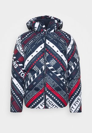 Navy, white, and red puffer jacket with hood, featuring diagonal stripes and repeated Tommy Jeans logos and text.