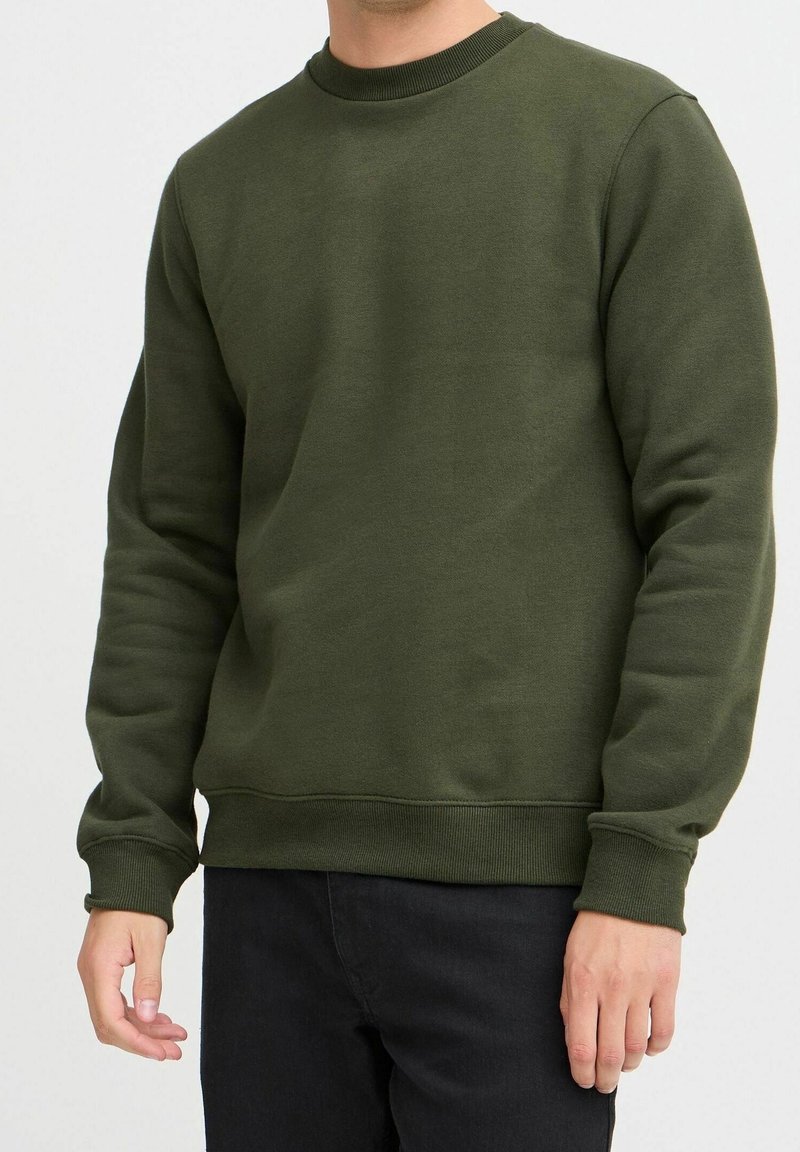 Groene fleece sweatshirt met een ronde hals, ribgebreide boorden en onderrand. De stof lijkt zacht en gestructureerd, ontworpen voor casual draagstijl.