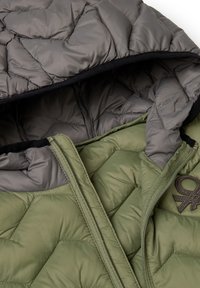 Quilted puffer jacket with a green exterior and gray interior. Features a hood, zipper closure, and a logo accent near the opening.