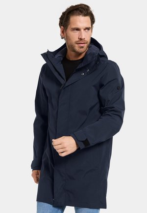 Marineblå vandtæt parka med hætte, trykknapper, justerbare manchetter og en glat tekstur, der har et længere design.