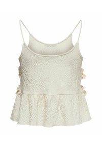 Haut sans manches pour femme à texture crème avec fines bretelles, ourlet volanté et nœuds décoratifs latéraux sur fond blanc.