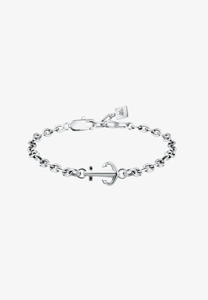 Bracciale in argento a forma di ancora con anelli chiusi interconnessi e chiusura a moschettone. Piccola etichetta con logo attaccata alla catena. Texture liscia.