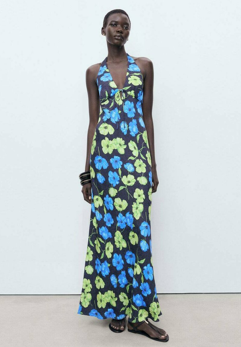 Halter-neck maxi dress in dark fabric with bright blue and green floral patterns; features a fitted bodice and flowing skirt.