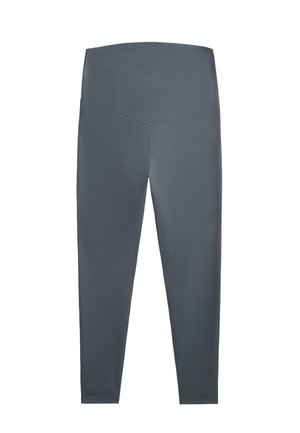 Leggings grigi con un tessuto liscio ed elastico. Vita alta con un dettaglio di cucitura a forma di V sul retro, gambe aderenti, senza motivi o accenti visibili.