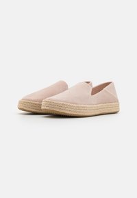 Light pink suede slip-on espadrilles with a woven jute sole. Low-cut design at the sides and textured finish. Flat rubber outsole for grip.