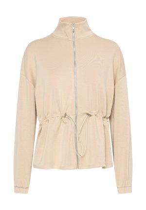 Chaqueta beige con cremallera, cuello alto, cintura fruncida y mangas largas. Presenta un cordón en la cintura y una textura de tela suave.