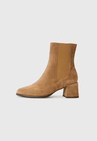 Suede ankle boot in tan with a block heel and elastic side panels. Features a pointed toe and smooth texture for added detail.