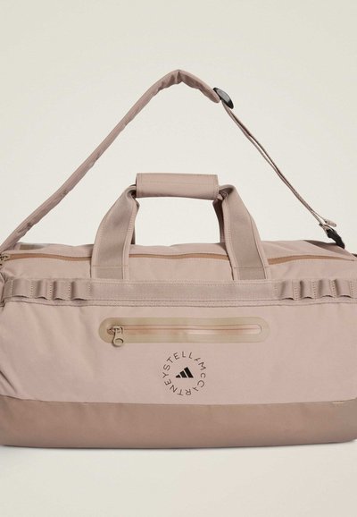 Ροζ τσάντα duffle από πολυεστέρα με διπλές λαβές, ρυθμιζόμενο ιμάντα ώμου, κλείσιμο με φερμουάρ και λογότυπο μπροστά. Διαθέτει υφή υφάσματος και θήκη.
