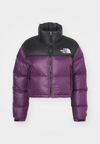 Purple and black cropped puffer jacket with high collar, front zipper, side pockets, and The North Face logo on the chest.