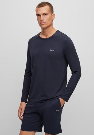 Navy long-sleeve shirt and matching shorts made of smooth fabric, featuring a subtle "BOSS" logo on the chest and shorts' hem.