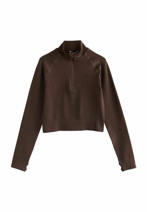 Brown cropped pullover with a high collar, half zipper, and ribbed texture. Features fitted long sleeves with thumbholes and raglan seams.