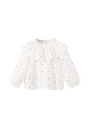 Blouse blanche à manches longues avec un col à volants et une broderie florale. Confectionnée en tissu léger, présentant une coupe décontractée et des poignets élastiques.