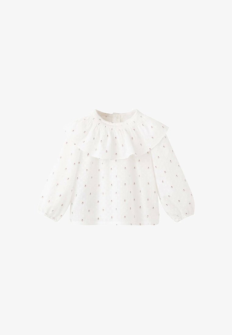 Biela blúzka s dlhým rukávom, volánikom na výstrihu a kvetinovou výšivkou. Vyrobená z ľahkej látky, s voľným strihom a elastickými manžetami.