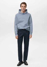 Light blue hooded sweatshirt with long sleeves, paired with dark navy trousers and black leather shoes. Smooth texture, casual fit.
