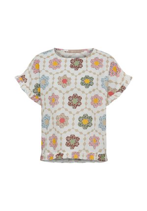 Kortærmet bluse med flerfarvet blomstermønster i sekskanter, flæser på ærmer og kant på en beige geometrisk baggrund.