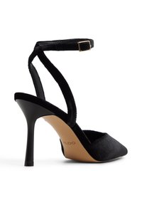 Schwarze Wildleder-Pumps mit hohem Absatz und verstellbarem Knöchelriemen, spitzem Schuhboden und glänzendem schwarzen Stiletto-Absatz, ausgestattet mit einer hellbraunen Innensohle mit Logo.