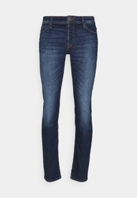 Jeans de mezclilla azul oscuro con un ajuste slim, que cuentan con un diseño clásico de cinco bolsillos y un ligero desgaste en los muslos. Cierre con botón y cremallera estándar.