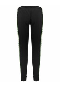 Pantaloni della tuta neri con vestibilità affusolata, caratterizzati da strisce laterali a motivo verde e giallo e una morbida cintura elastica.