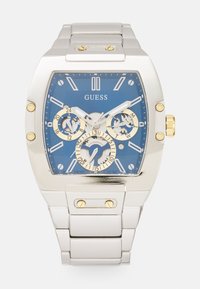 Silver stainless steel watch with a blue dial, gold accents, three sub-dials, and a rectangular case design featuring luminous hands and markers.