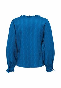 Blouse bleue à manches longues avec un col volé, un motif zigzag texturé et des poignets boutonnés. Fabriquée en tissu léger.