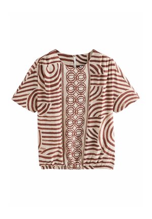Blouse beige à manches courtes avec motifs géométriques marron de cercles et de lignes, encolure ronde et ourlet élastique à la taille.