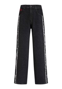 Wide-leg black denim jeans featuring frayed white side stripes and a small red embroidered detail on the front pocket.