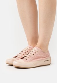 Light pink sneakers made of suede with a smooth leather toe cap, round laces, and metal eyelets; features the brand "CANDICE COOPER" on the side.