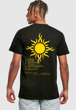 Black cotton t-shirt featuring a large yellow sun graphic with stylized rays and a vertical list of song titles printed below.