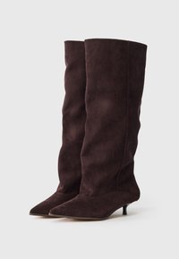 Burgundy knee-high boots in suede with a pointed toe and a low, slim heel; soft texture with slight creasing along the shaft.