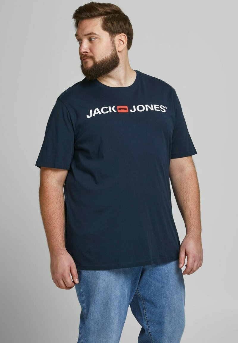 Navy blue cotton t-shirt featuring a white logo that reads "JACK JONES" with a small red box accent, round neckline, and short sleeves.