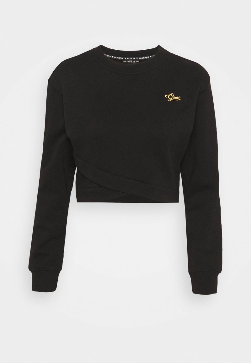 Sweat-shirt court noir à manches longues avec logo doré "Guess" sur la poitrine gauche et poignets côtelés.