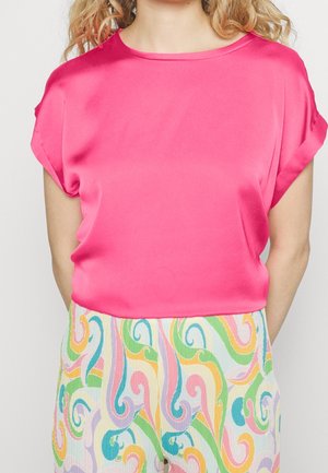 Pink satin top med korte opkrøllede ærmer, kombineret med mønstrede lette bukser i pastelfarvede hvirvler af grøn, gul og pink.