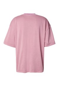 Růžové tričko s krátkými rukávy, volného střihu, vyrobené z lehké bavlny. Má kulatý výstřih a jednoduchý, hladký design bez dalších ozdob či vzorů.