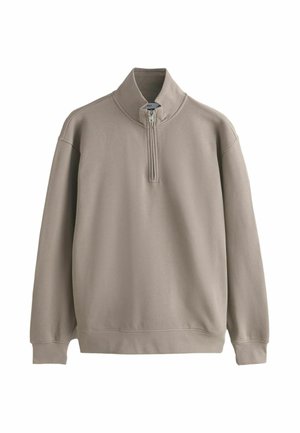 Beige long-sleeve pullover with a quarter zip and high collar, featuring ribbed cuffs and waistband, displayed on a white background.