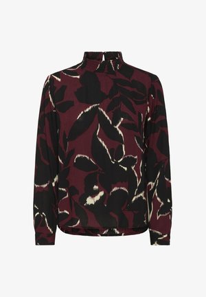 Long-sleeve blouse with high ruffled neckline, featuring a large abstract leaf pattern in black and cream on a dark burgundy background.