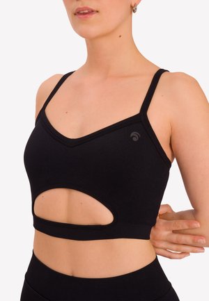 Top reggiseno nero con design a V e ritagli aperti sui lati, realizzato in un materiale elasticizzato. Presenta spalline sottili e un piccolo dettaglio con logo.